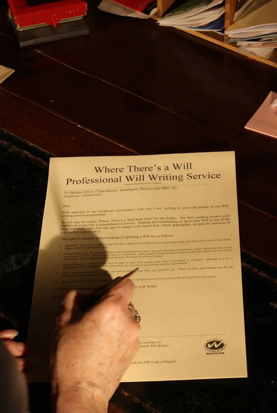 Hand signing a will document from Where There's A Will : Southport : Merseyside